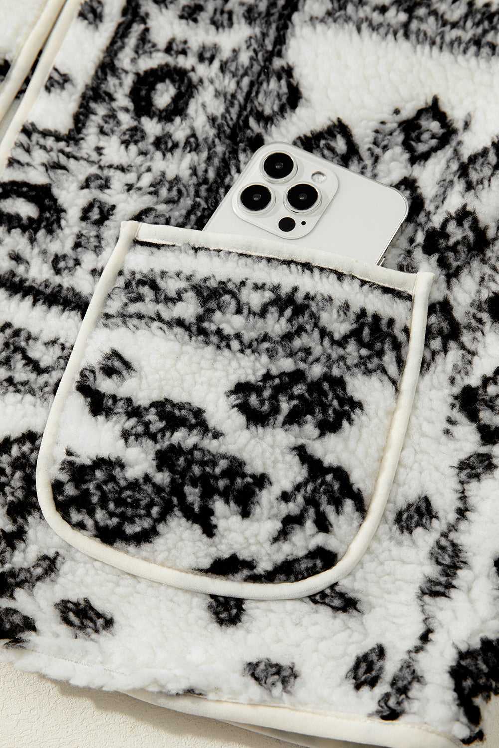 Front pocket of Paisley Sherpa Gilet holding a smartphone, showcasing functionality and stylish Western design.