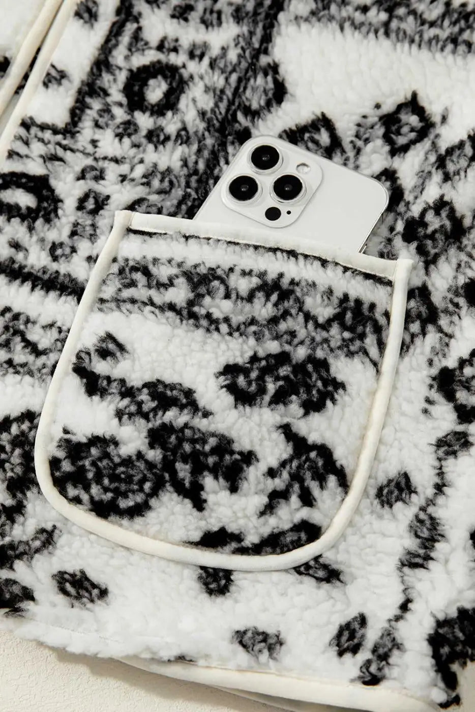 Front pocket of Paisley Sherpa Gilet holding a smartphone, showcasing functionality and stylish Western design.