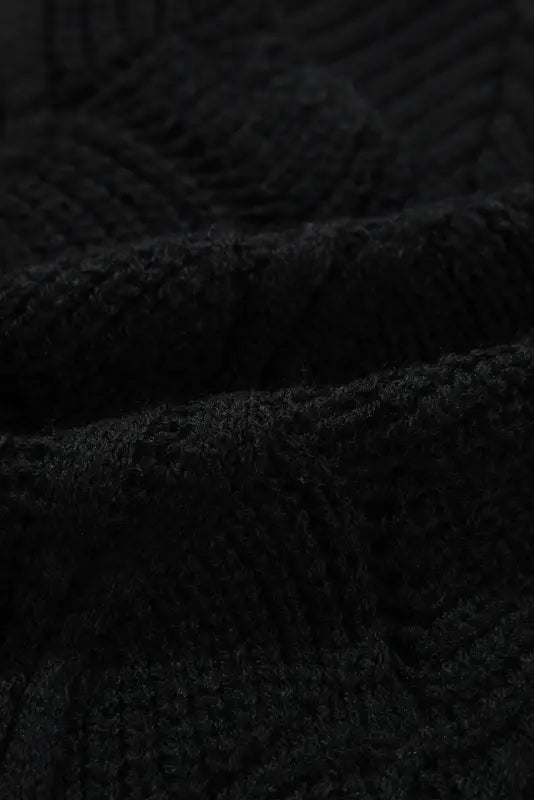 Airy charm drop sweater in dark, textured fabric with a visible weave pattern