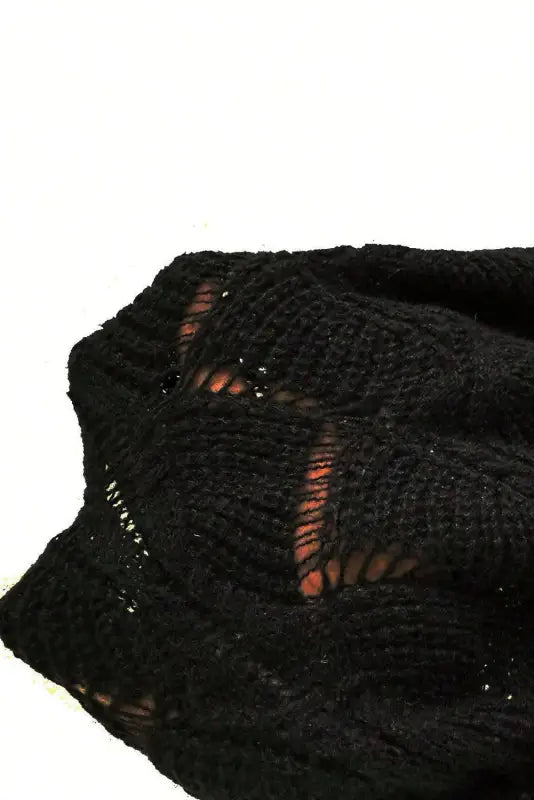 Black knit fabric with a lacy pattern from the airy charm drop sweater for relax relax style