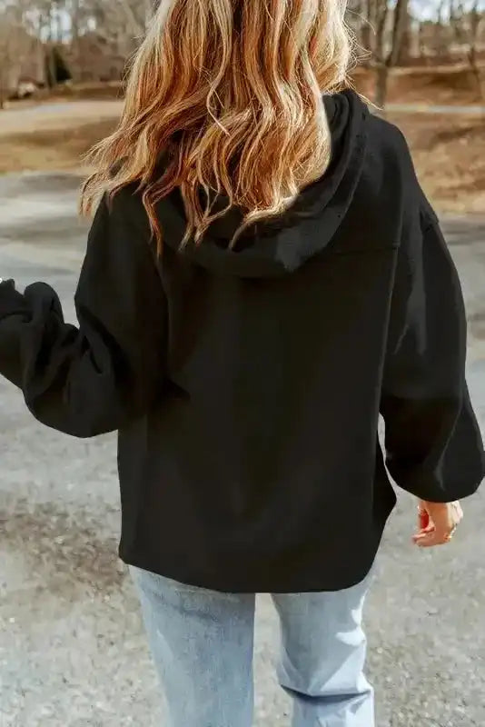Back view of black zip up hooded jacket women with relaxed fit and cozy fleece fabric. Ideal for casual cold-weather outfits.