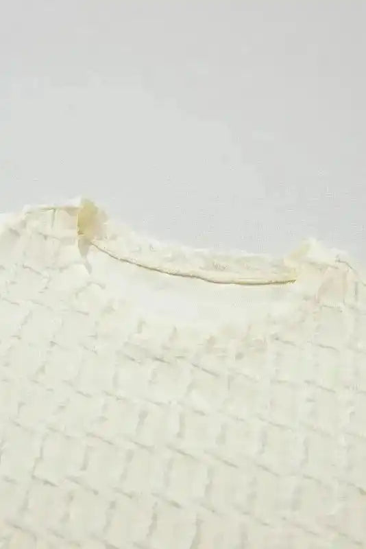 Neckline detail of Apricot Lattice Top showing round collar and textured fabric for a casual summer look.