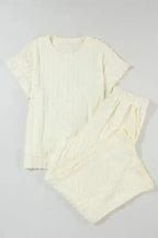 Flat lay of Apricot Lattice Two Piece Set showing batwing top and flared pants in soft textured fabric.