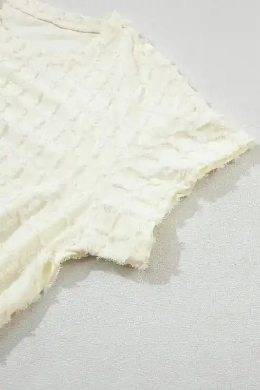 Close-up of batwing sleeve from Apricot Lattice Top, featuring soft textured fabric and relaxed fit.