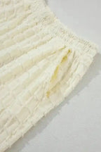 Detail of elastic waistband and pocket on Apricot Lattice Two Piece Pants, designed for comfort and function.