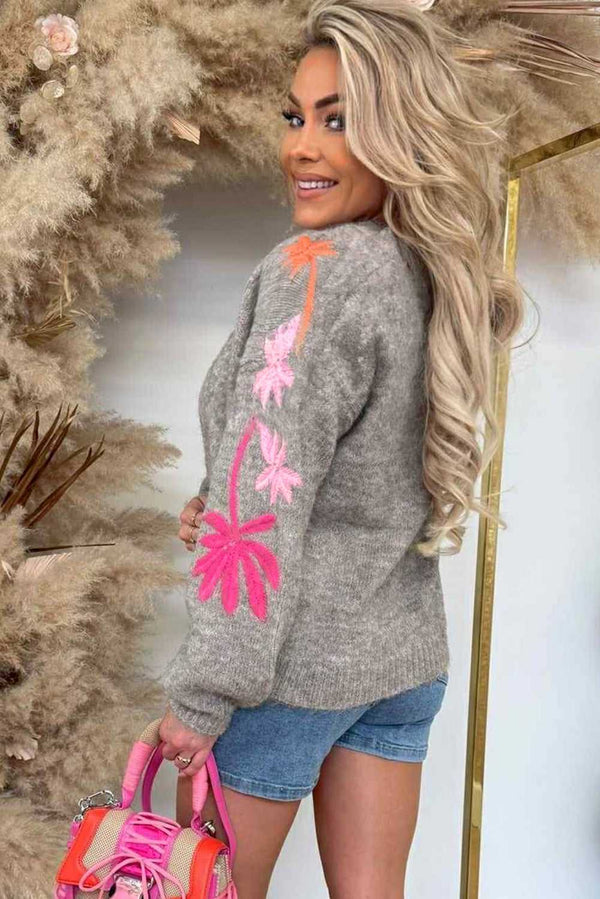 Back view of grey Women's Floral Embroidered Sleeve Jumper featuring vibrant floral embroidery, paired with denim shorts for casual styling.
