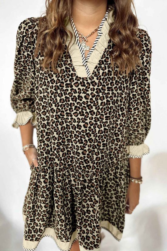 Close-up front of Leopard Print Striped Trim Mini Dress showcasing detailed striped ruffle trim on neckline and sleeves for a chic finish.