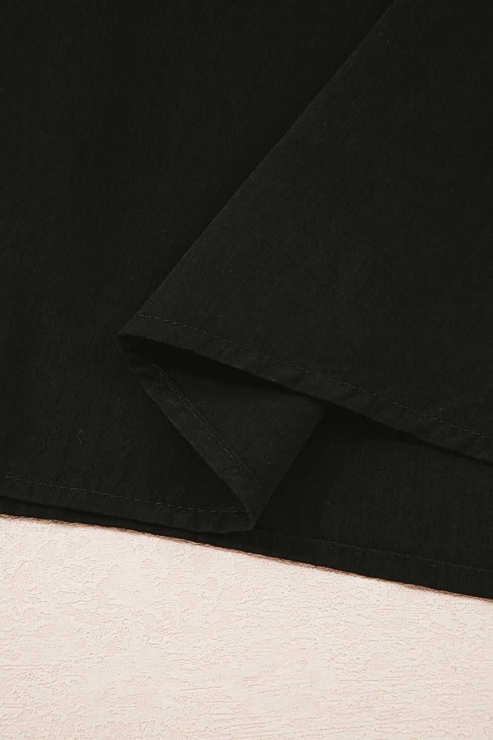 Hem detail of Monochrome Knit Dress - Cozy & Stylish | FashionFitz showing clean stitching and lightweight black skirt fabric.