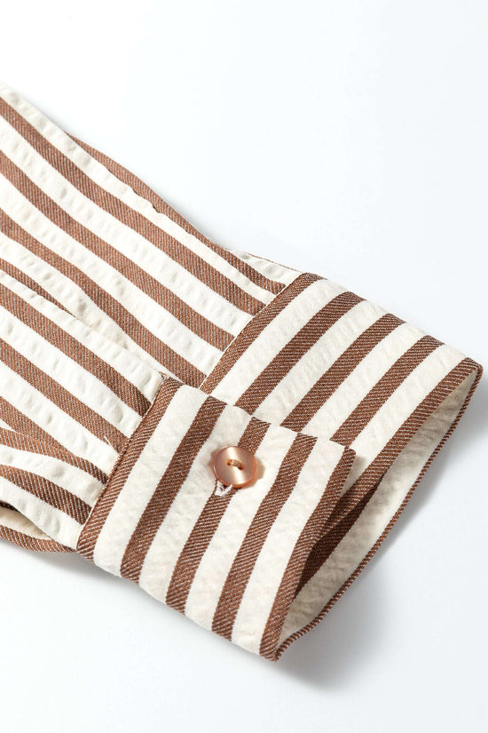 Cuff detail of brown striped midi shirt dress with button closure, showcasing lightweight fabric and casual style.