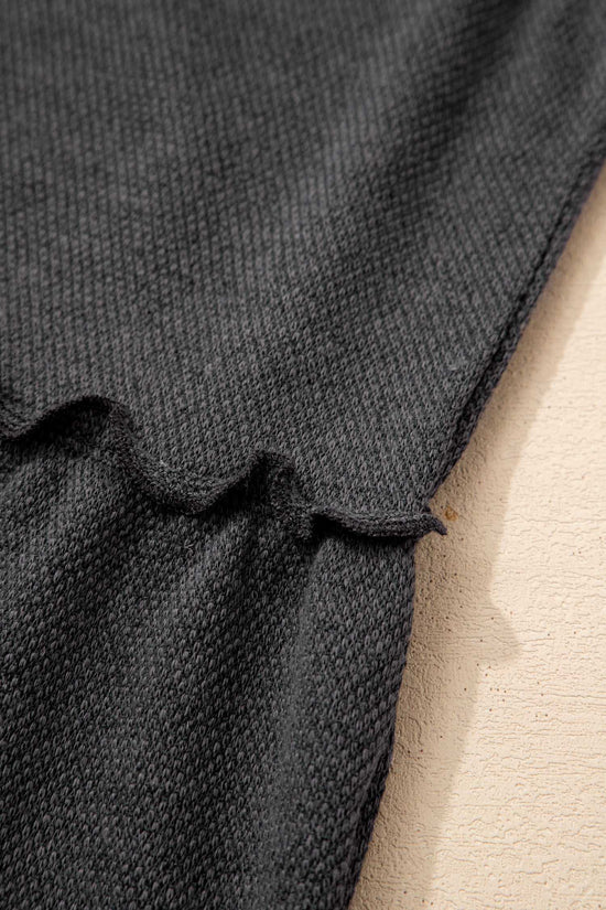Detail shot of ruffle seam and fabric texture on dark grey tiered frill tank top for women, emphasizing quality stitching.