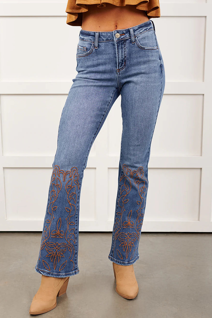 Embroidered flare leg jeans — close-up of intricate embroidery detail