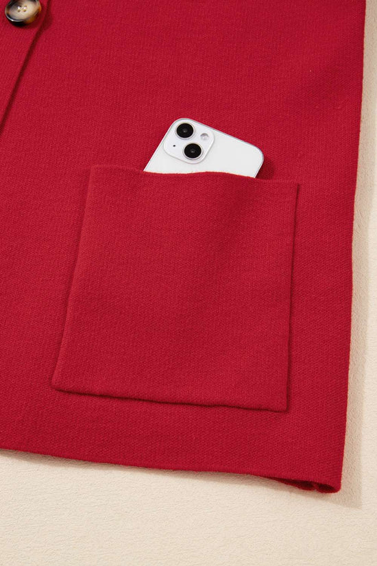 Front pocket of the Red Wrap Cardigan Jacket holding a smartphone, showcasing functional design and storage convenience.