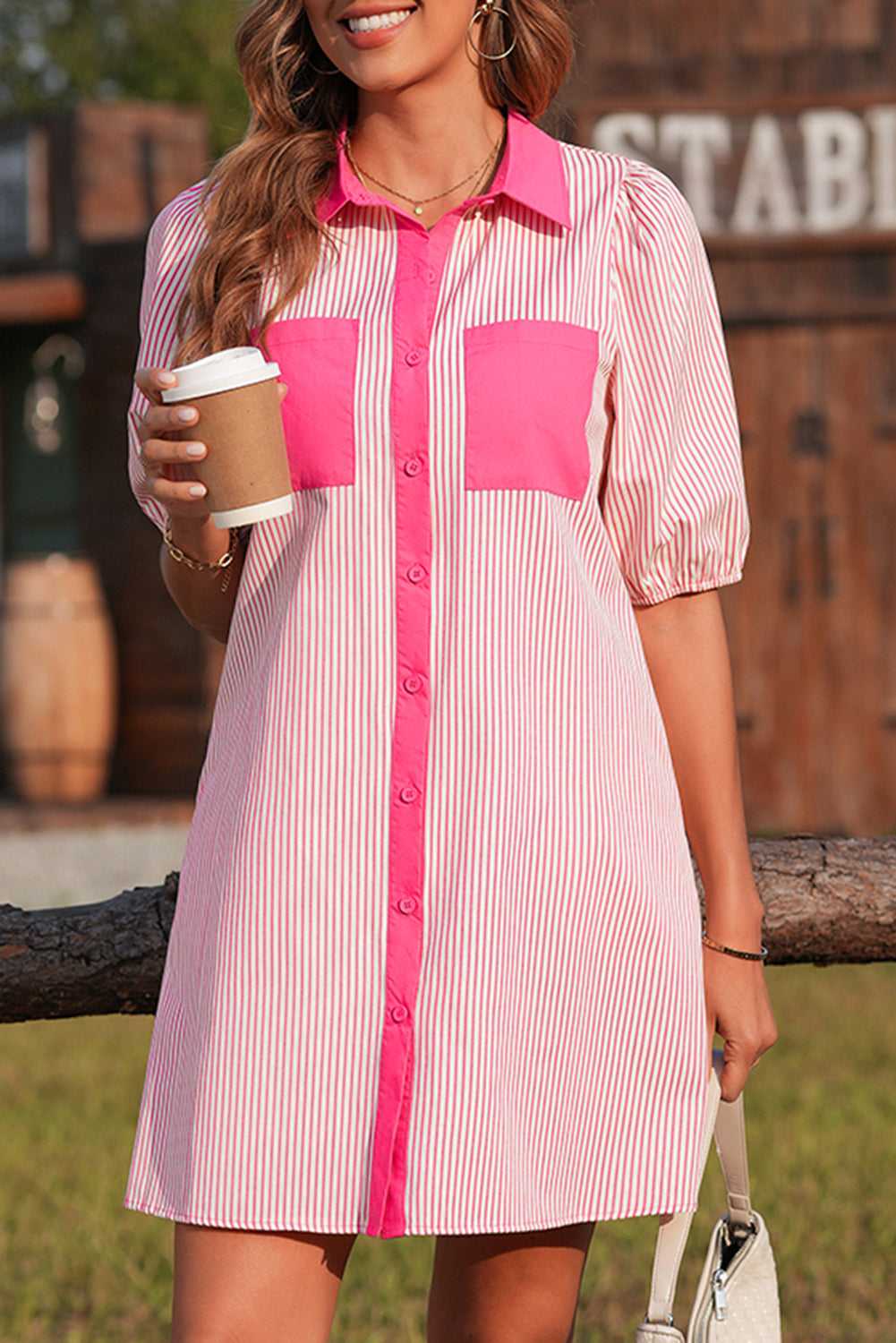 Front view of pink striped puff sleeve mini dress with hot pink accents, styled for a casual day out with a feminine touch.