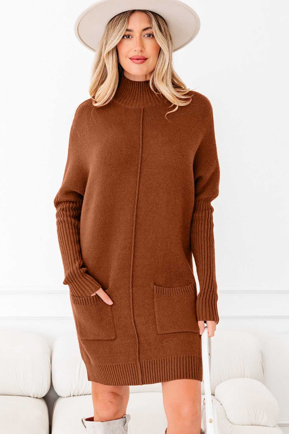 Brown version of high neck knit jumper dress with front pockets and ribbed sleeves. Stylish women’s winter dress in warm solid color.