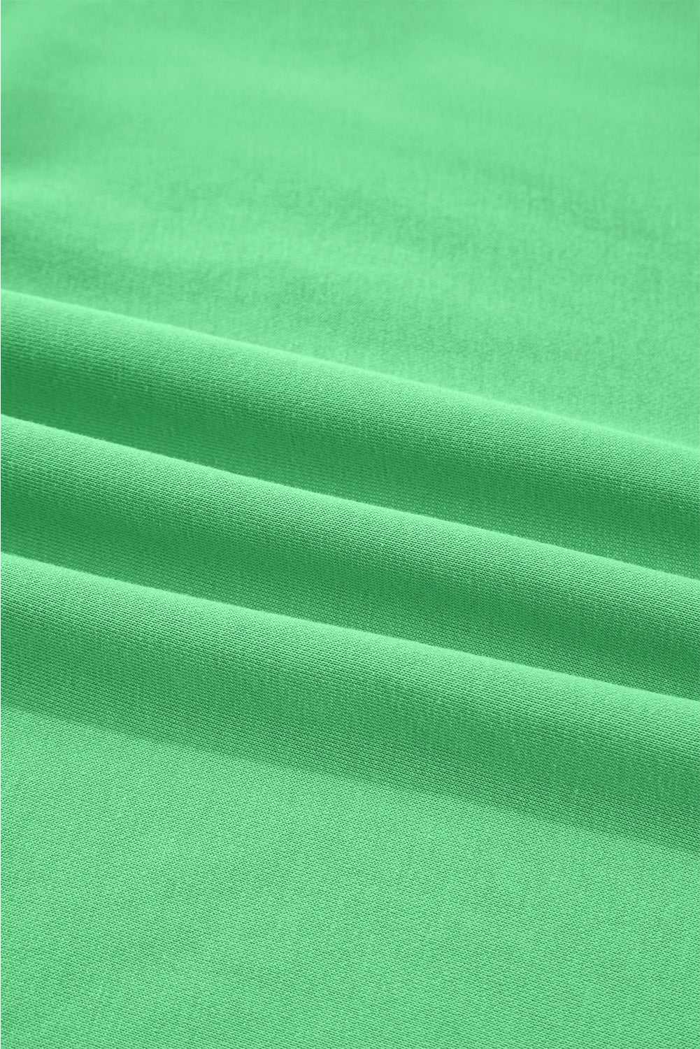 Close-up of green Drop Crop fabric texture, emphasizing soft, breathable material ideal for fall loungewear sets.