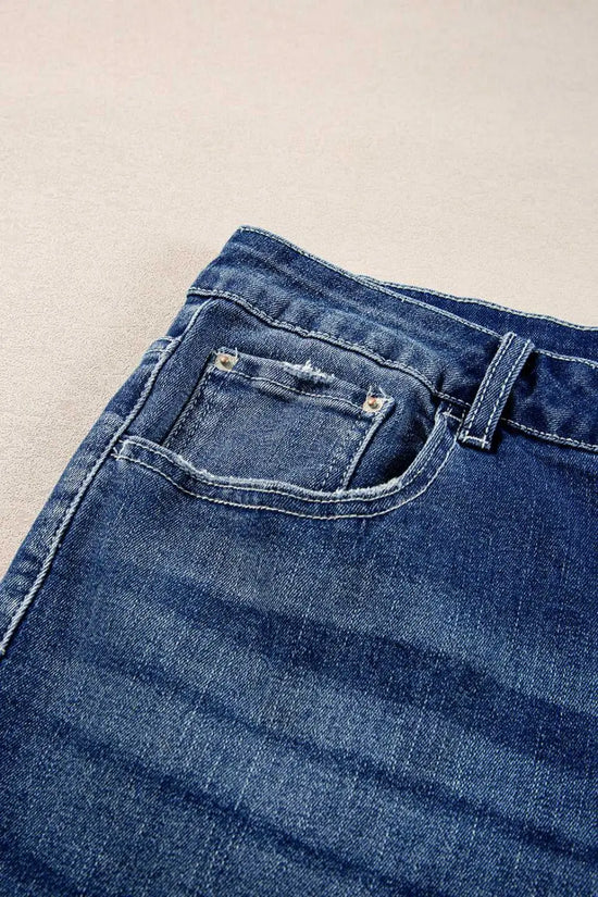 Close-up of Dirty Blue Side‑Slit Flare Jeans – Curve front pocket and waistband, showcasing denim texture and stitching details.