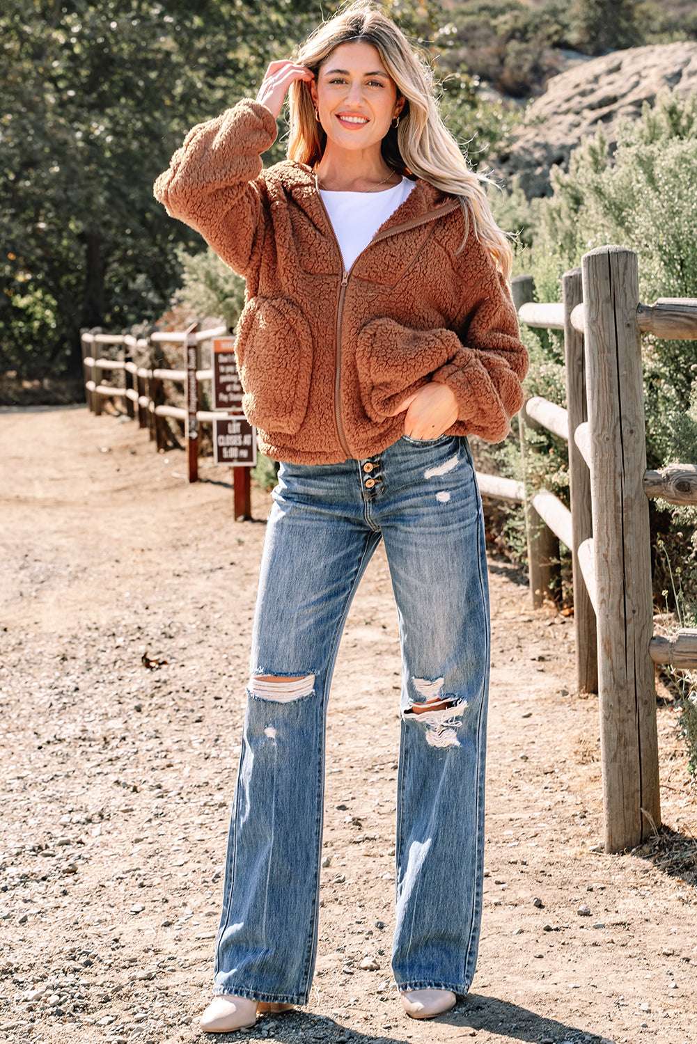 Full-body view of Women's Zip‑Up Sherpa Hoodie Jacket paired with distressed jeans, ideal for casual winter outings.