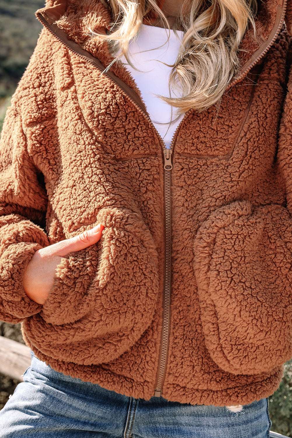 Close-up of Women's Zip‑Up Sherpa Hoodie Jacket pockets and fleece texture, emphasizing warmth and plush material.