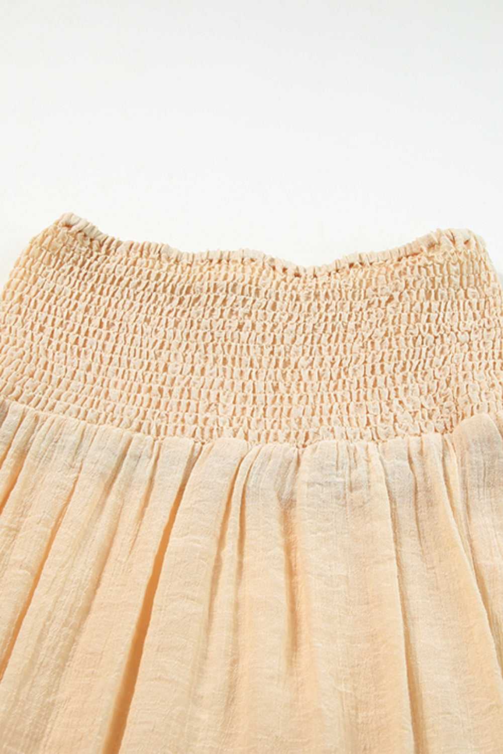 Close-up of beige shirred beach skirt waistband