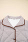 Close-up of the collared neckline and snap buttons on the Stripe Snap Winter Vest, showcasing its cozy and structured design.