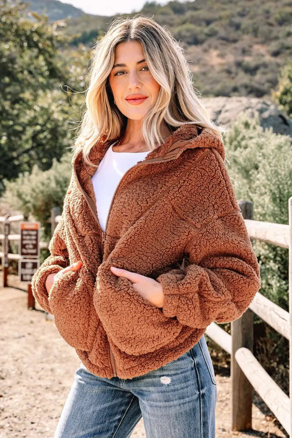 Cozy brown Women's Zip‑Up Sherpa Hoodie Jacket partially unzipped, highlighting thick fleece texture and casual winter style.