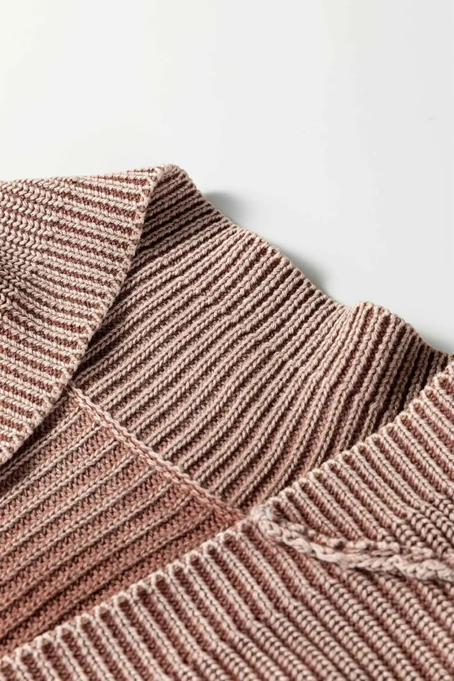 Close-up of collar on brown stonewash patchwork knit open cardigan, showcasing fine ribbed detailing and soft texture.