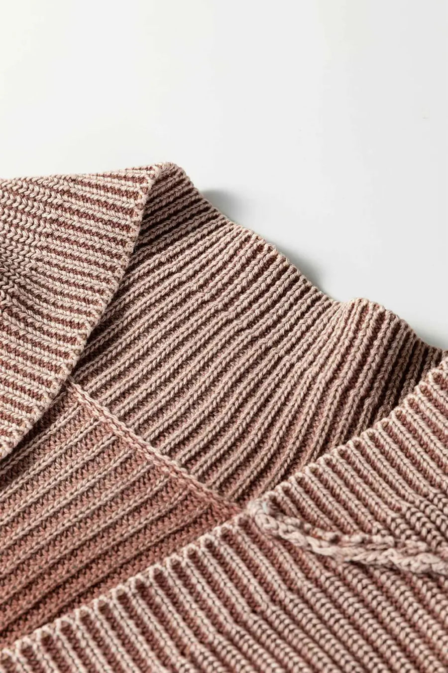 Close-up of collar on brown stonewash patchwork knit open cardigan, showcasing fine ribbed detailing and soft texture.