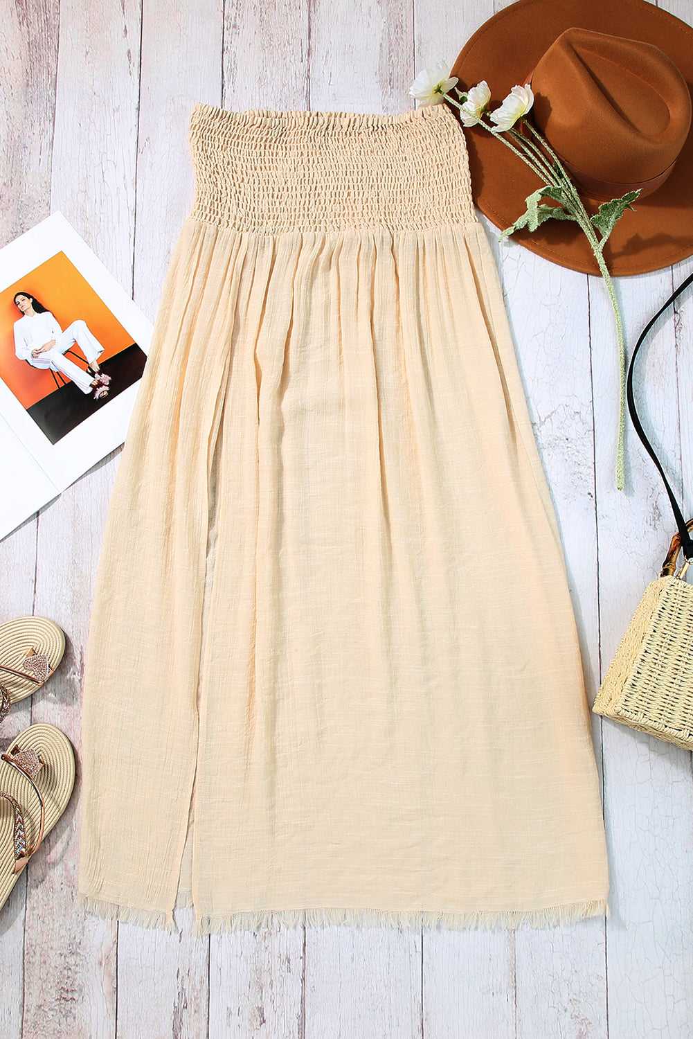 Beige shirred beach skirt flat lay with accessories