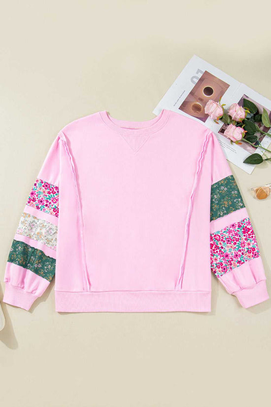 Flat lay of Curve Pink Floral Sleeve Baggy Sweatshirt for Women with floral patchwork sleeves, styled with accessories for a feminine casual look.
