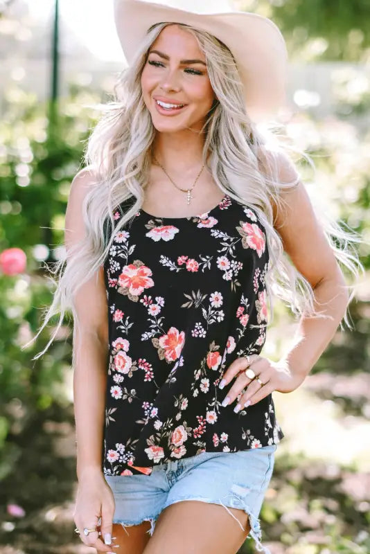 Woman in beige floral strappy back tank top, long blonde hair, bust hem width, denim shorts