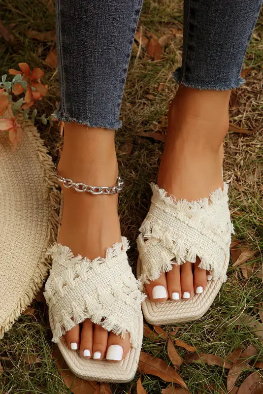 Beige tassel woven crossed straps flat slippers