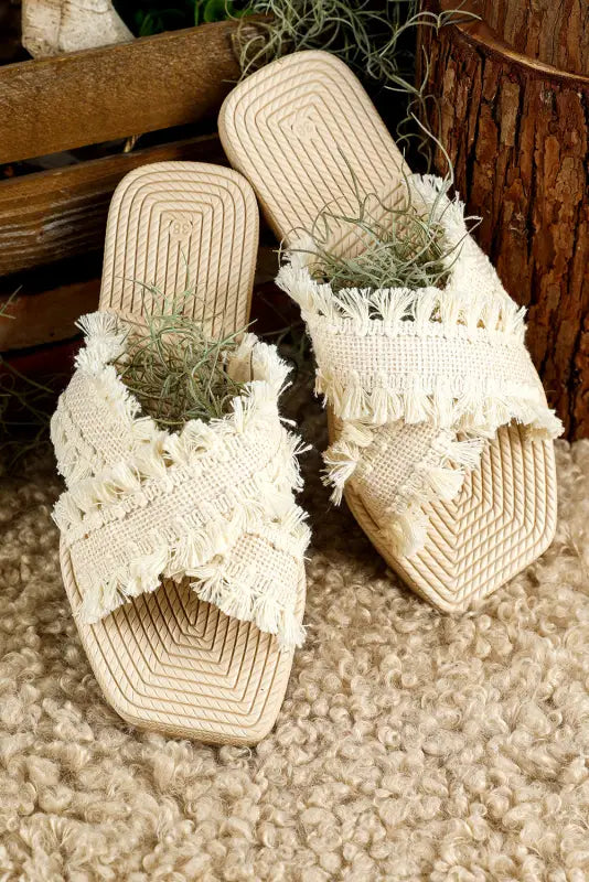 Beige tassel woven crossed straps flat slippers