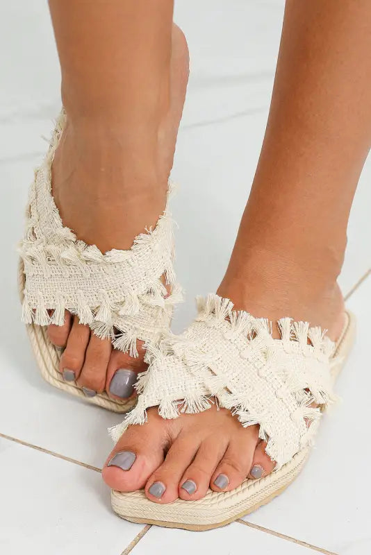 Beige tassel woven crossed straps flat slippers