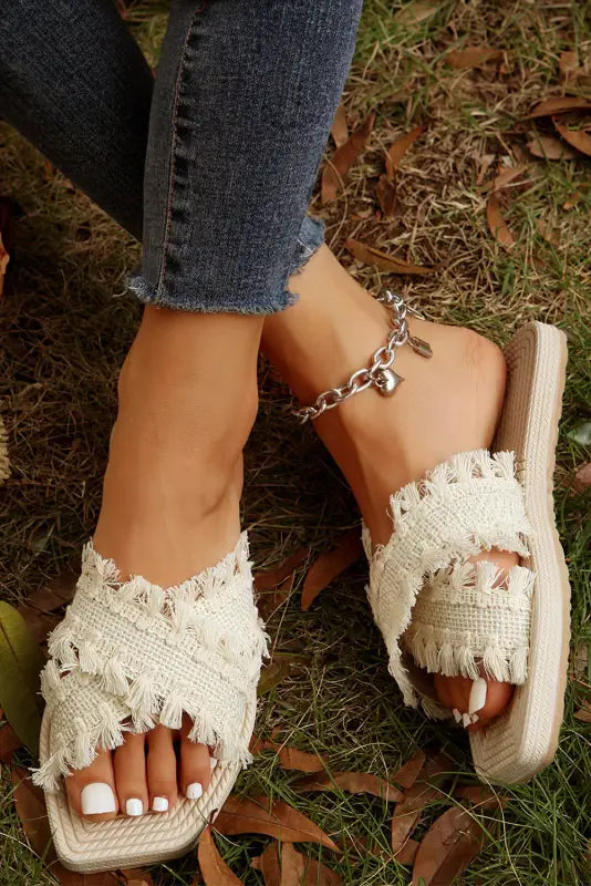 Beige tassel woven crossed straps flat slippers