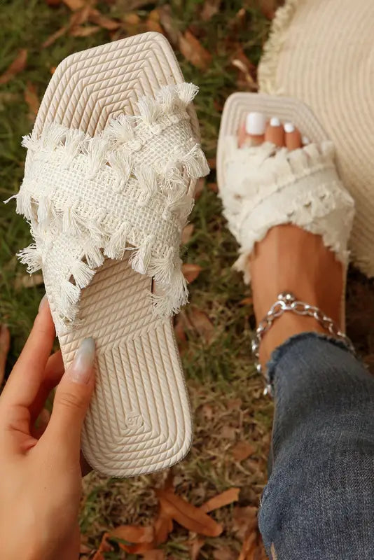 Beige tassel woven crossed straps flat slippers