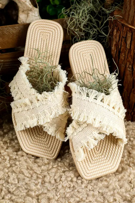 Beige tassel woven crossed straps flat slippers