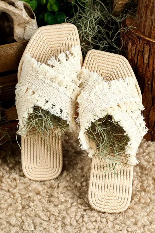 Beige tassel woven crossed straps flat slippers