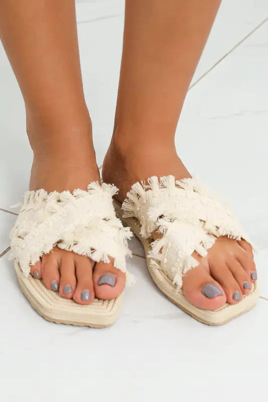 Beige tassel woven crossed straps flat slippers