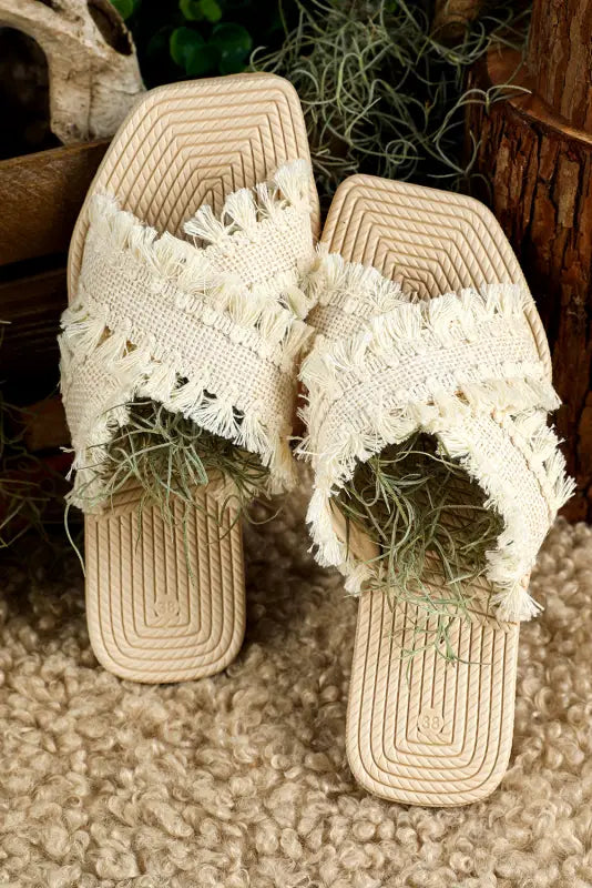 Beige tassel woven crossed straps flat slippers