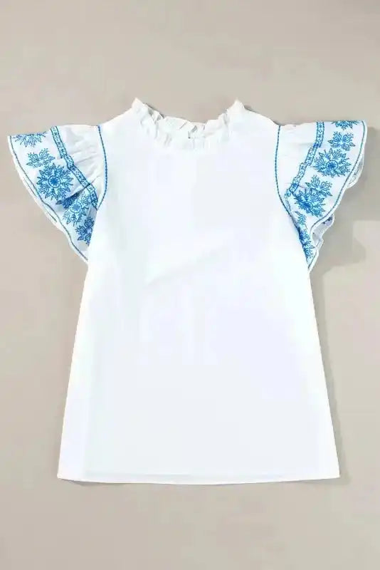 Close-up of White Embroidered Ruffled Sleeve Blouse showing intricate embroidery stitching and frilled collar — Fashionfitz
