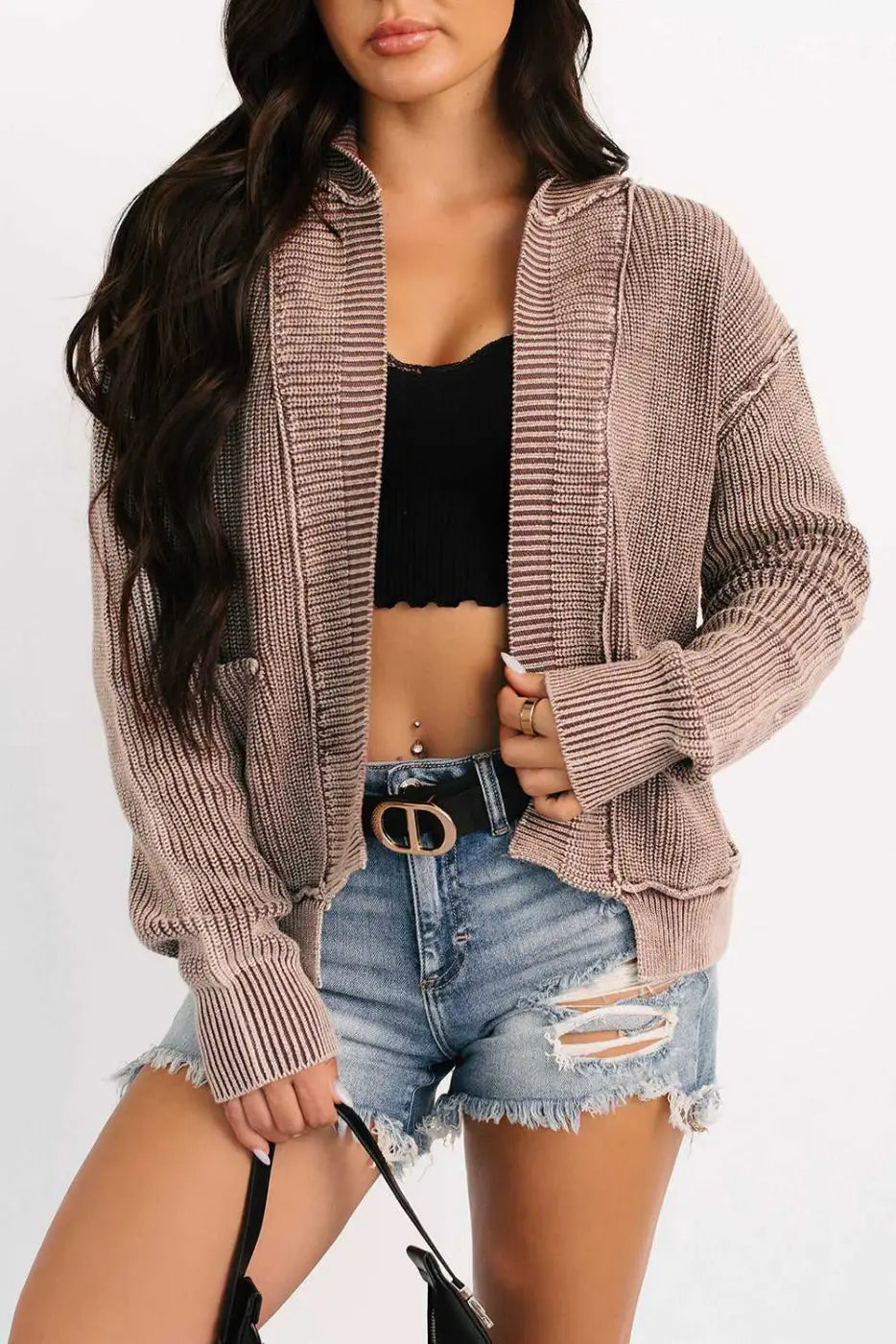 Woman wearing brown stonewash patchwork knit open cardigan with black crop top and distressed shorts, styled for casual outings.