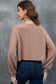 Woman wearing a Game Day Graphic Crop Top and blue jeans against a gray background