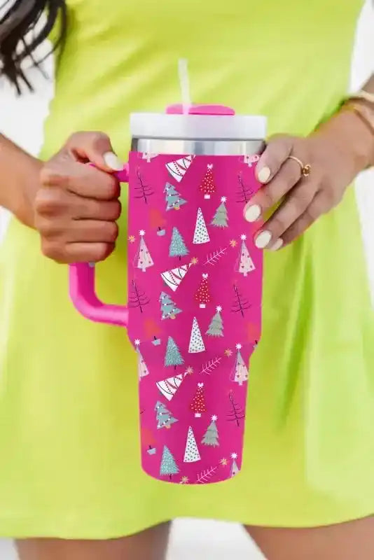 Vibrant pink thermos cup with cartoon Christmas tree design, includes handle and straw, perfect for holiday drinks on the go.