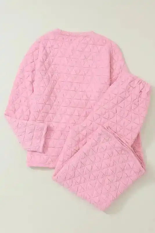 Back view of pink quilted loungewear set laid flat, showing soft texture and modern cozy design.
