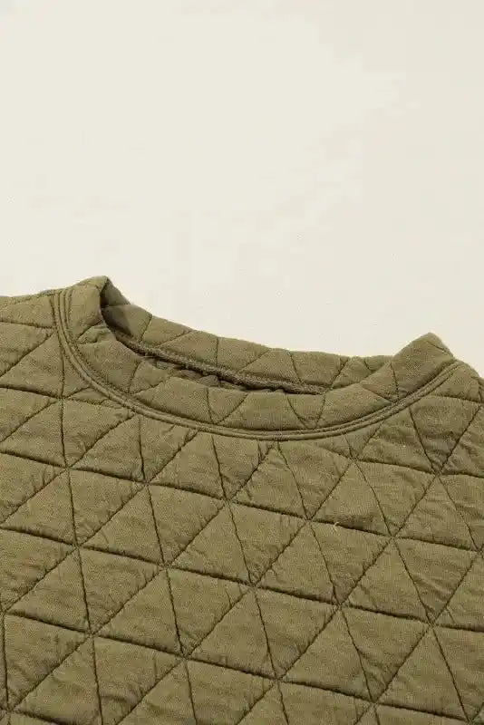 Neckline view of olive green quilted top from the modern style shorts set, showcasing round collar and textured fabric.