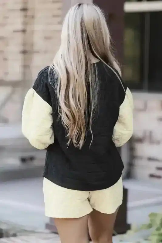 Back view of black and cream quilted loungewear set featuring relaxed fit and soft texture for modern comfort.