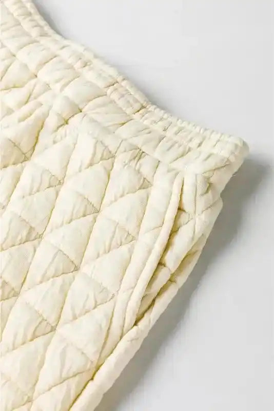 High waist cream quilted shorts with side pocket detail from modern loungewear set, ideal for comfort and style.