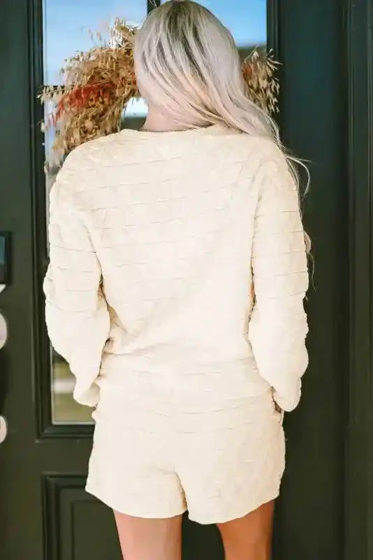 Back view of cream quilted shorts set with relaxed fit and textured fabric, perfect for modern loungewear comfort.