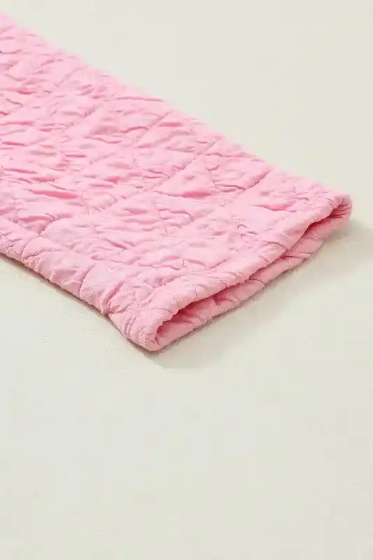 Sleeve hem detail of the pink quilted top from the Modern Style Quilted Shorts Set - Black, featuring cozy loungewear fabric.