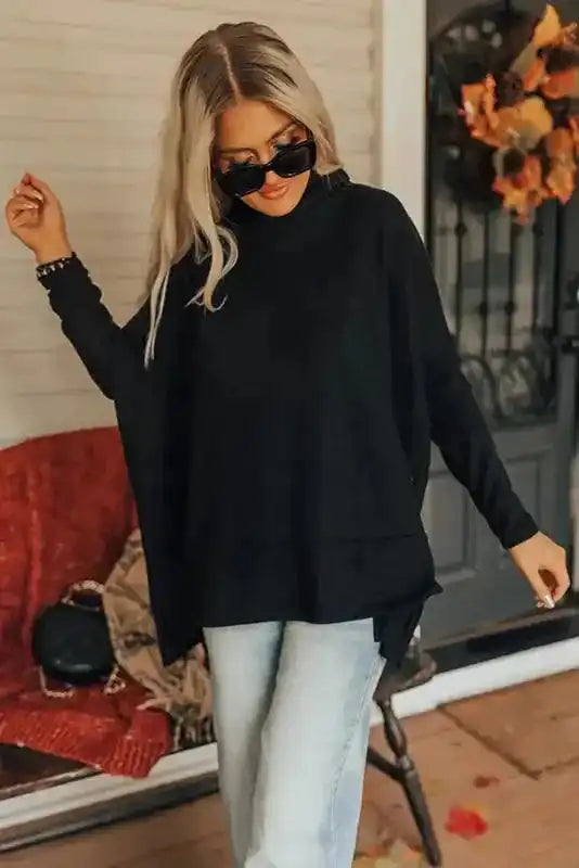 Casual black cowl neck shift tunic top paired with jeans, showcasing its loose fit and soft texture for daily wear.